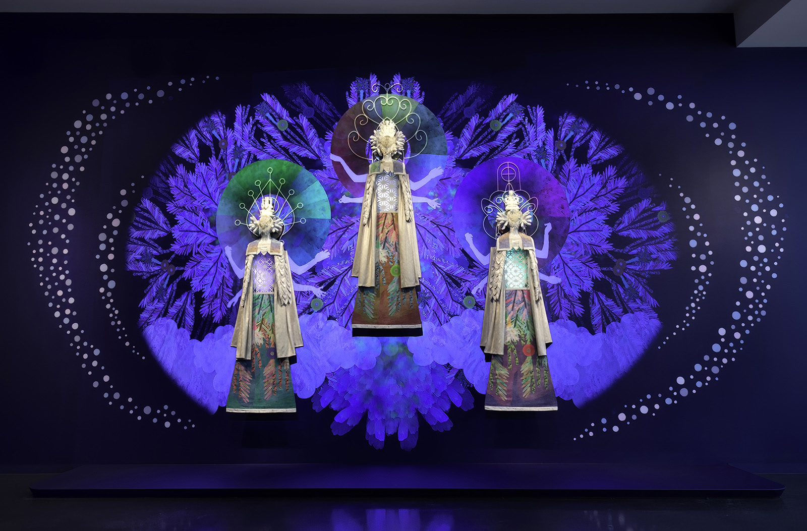 installation view of video projection with three figures